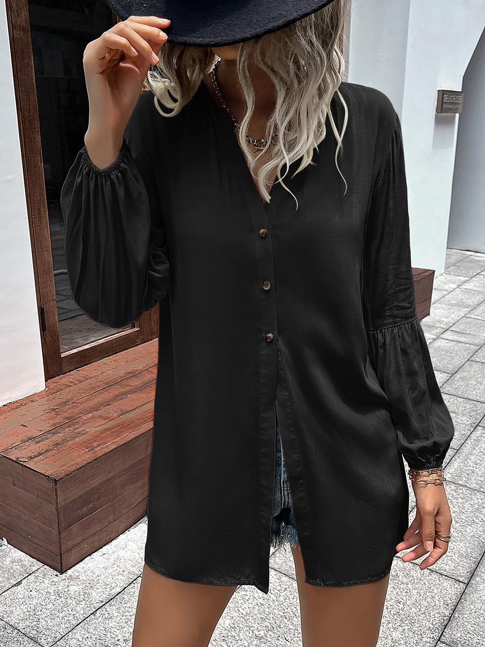 Black oversized blouse with Mandarin collar, button front, and balloon sleeves.