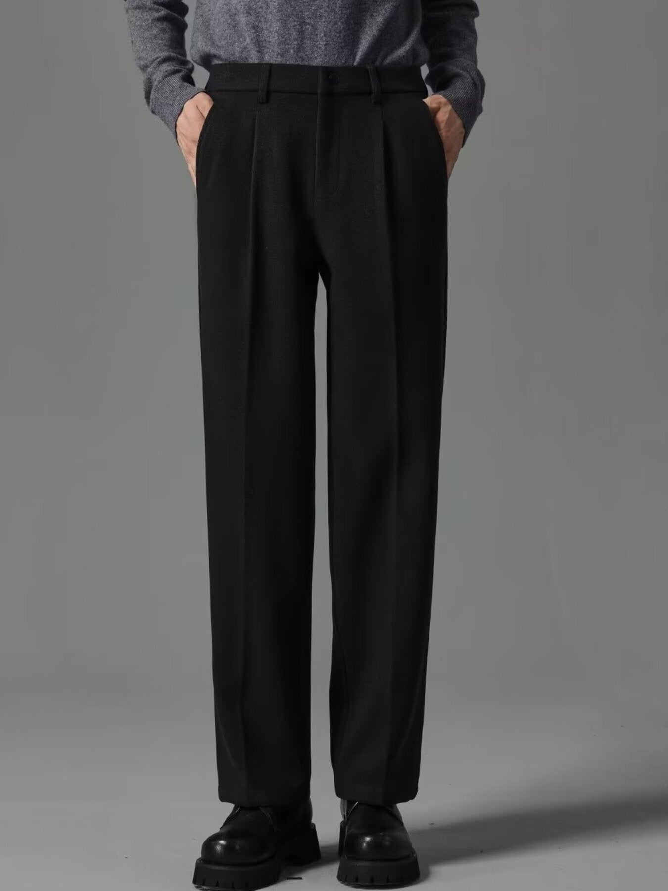 Men's black premium pocketed sweatpants with a relaxed fit and subtle pleats.