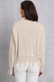 Apricot knit sweater with distressed hem and cuffs.