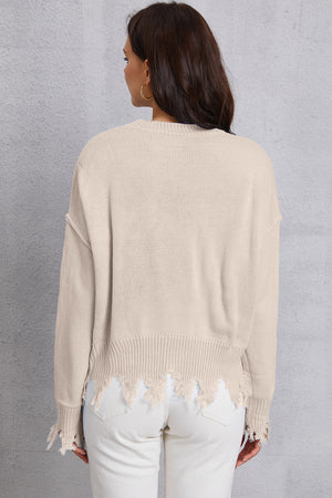 Apricot knit sweater with distressed hem and cuffs.