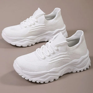 White textured knit sneakers with a chunky sole and lace-up closure.