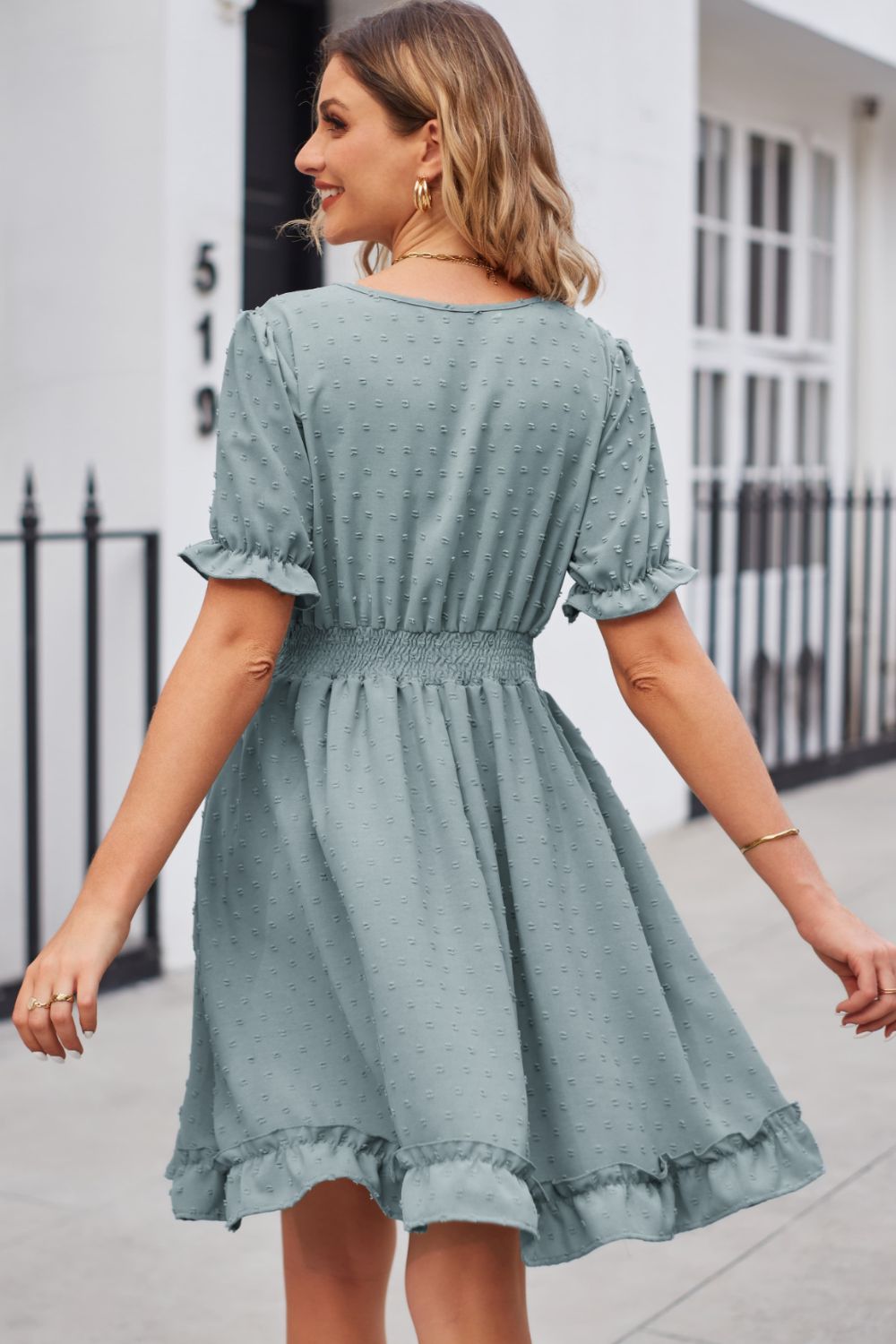 Teal textured dot puff sleeve fit-and-flare dress with ruffled hem and smocked waist.