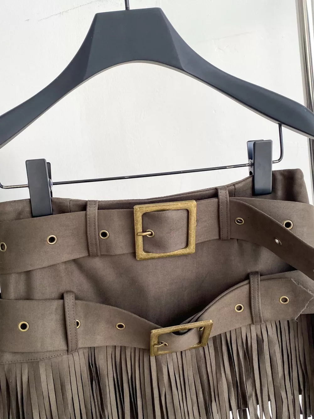 Khaki belted mini skirt with fringe and antique brass buckles.