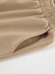 Camel quarter zip top and pants set detail showing elastic waistband and pocket.