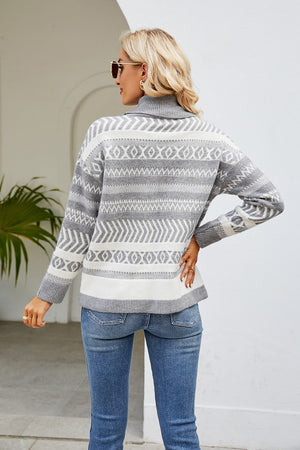 Light gray turtleneck sweater with geometric jacquard pattern and ribbed cuffs.