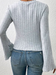 Gray ribbed knit top with flared sleeves and scalloped cuffs.