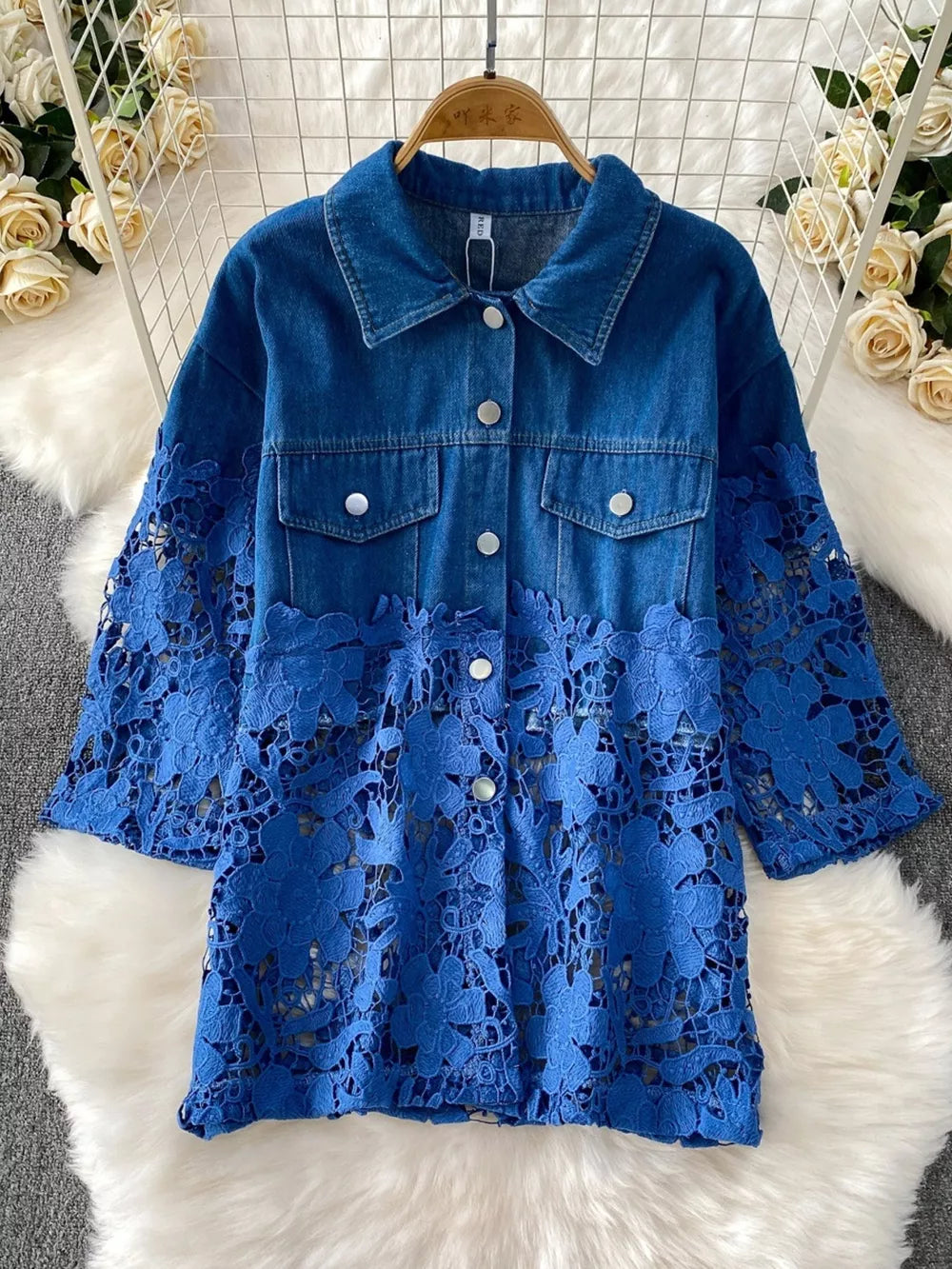 Blue denim jacket with lace sleeves and floral detail
