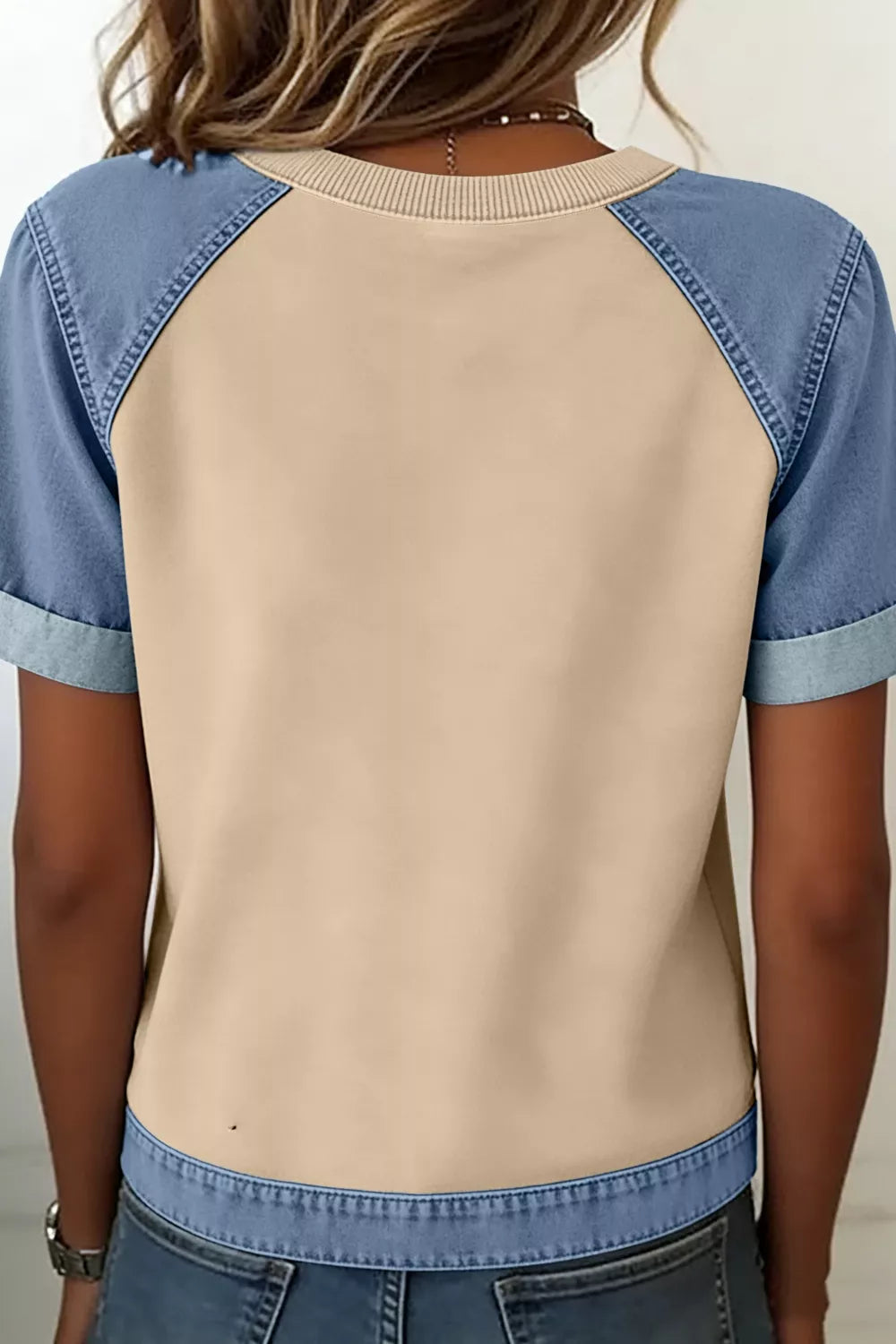 Color block t-shirt with tan body, blue denim sleeves, and round neckline.