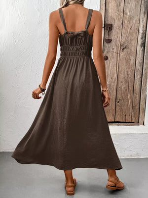 Coffee brown smocked midi dress with tie straps and a flowing skirt.