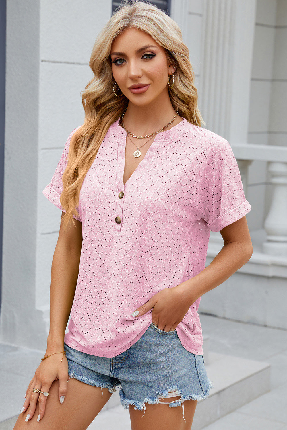 Blush pink textured henley tee with rolled sleeves and button detail