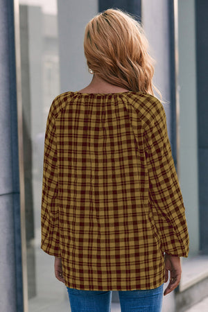 Gingham gathered neckline blouse in mustard and burgundy with balloon sleeves.