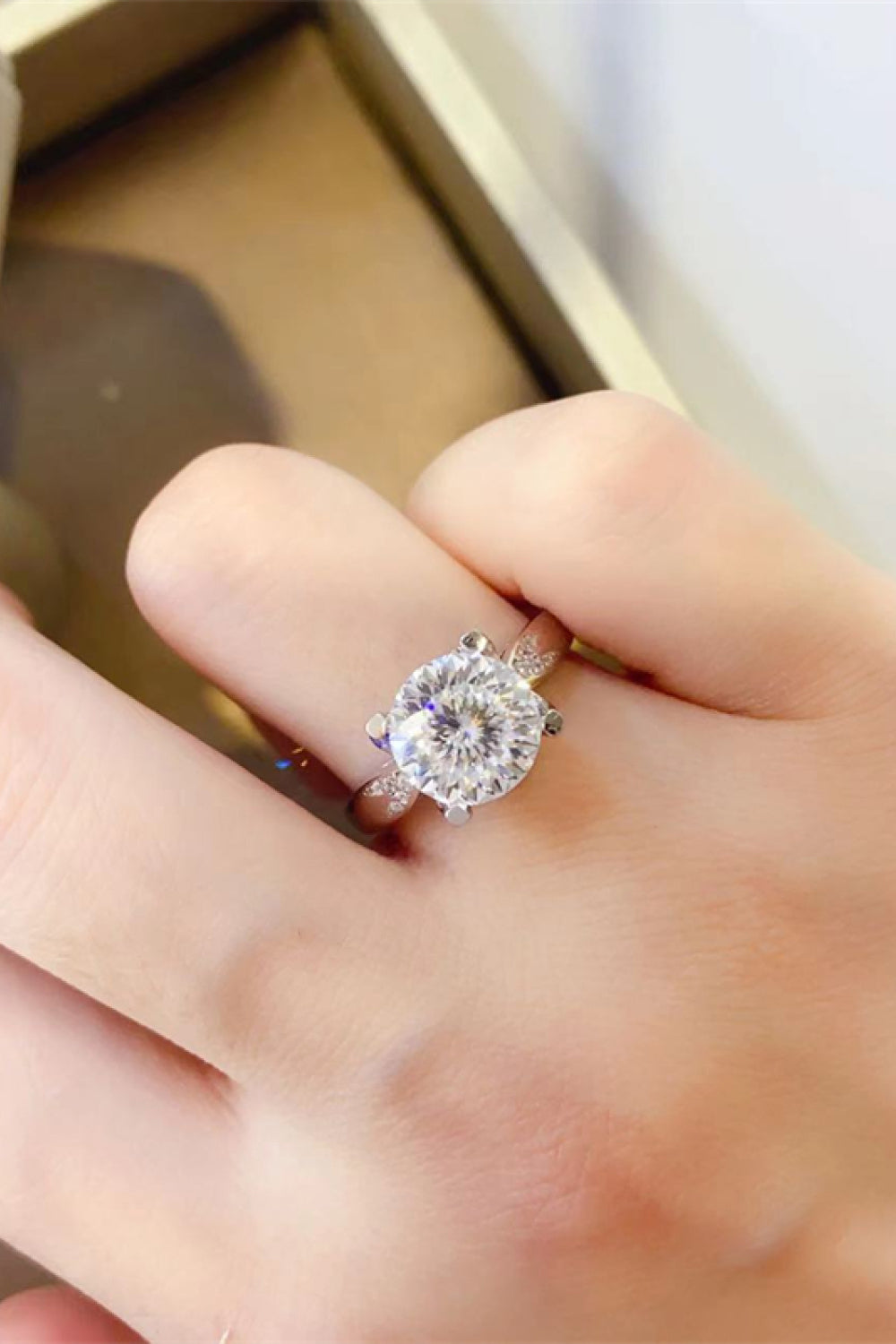 Sterling silver ring with a large round solitaire diamond and a halo of smaller diamonds.