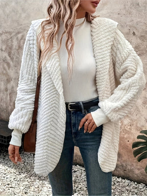 Textured ivory hooded cocoon coat with chevron pattern, open front, and cozy fleece material.