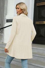 Drape-front cable knit cardigan in Sand, featuring a textured pattern and long sleeves.