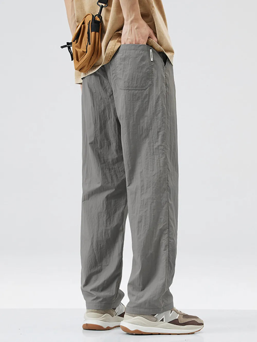 Relaxed fit wide-leg sweatpants in dark gray with a textured fabric and pockets.