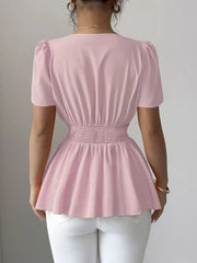 Pink peplum blouse with smocked waist and puff sleeves