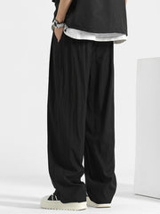 Black loose fit casual sweatpants with elastic waistband and pockets.