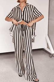 Vertical stripe lounge set with cutout top and drawstring pants in white and black.