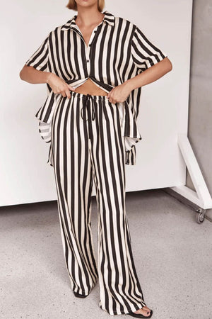 Vertical stripe lounge set with cutout top and drawstring pants in white and black.