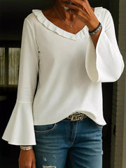 White polyester blouse with ruffled V-neck and dramatic bell sleeves.