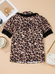 Women's leopard print short sleeve shirt with black lace trim collar and cuffs.