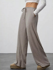 Relaxed wide-leg pants in dark gray with drawstring and ribbed texture.