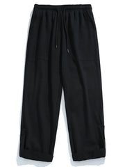 Black relaxed fit cuffed cargo trousers with drawstring waist and button detail.