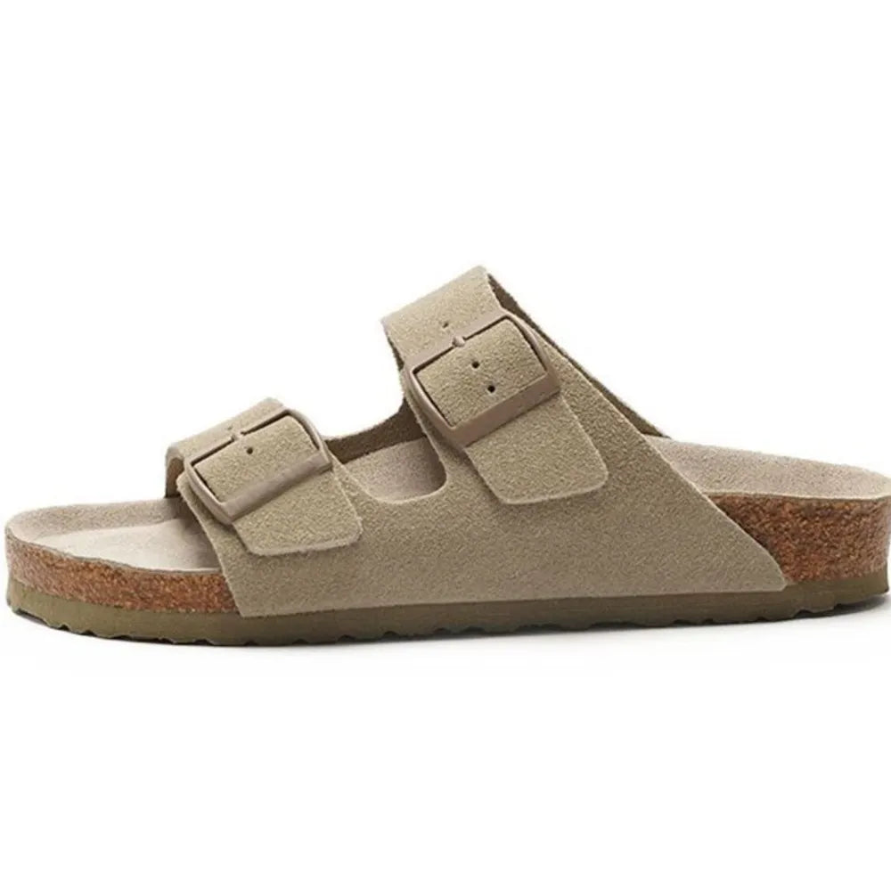 Suede slide sandals in beige with two adjustable buckles and cork footbed.