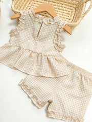 Children's beige gingham ruffle two-piece set with ruffled neckline and hem shorts.