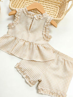 Children's beige gingham ruffle two-piece set with ruffled neckline and hem shorts.