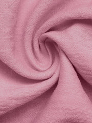 Pink maternity wrap romper fabric detail with textured weave.