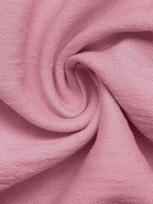 Pink maternity wrap romper fabric detail with textured weave.