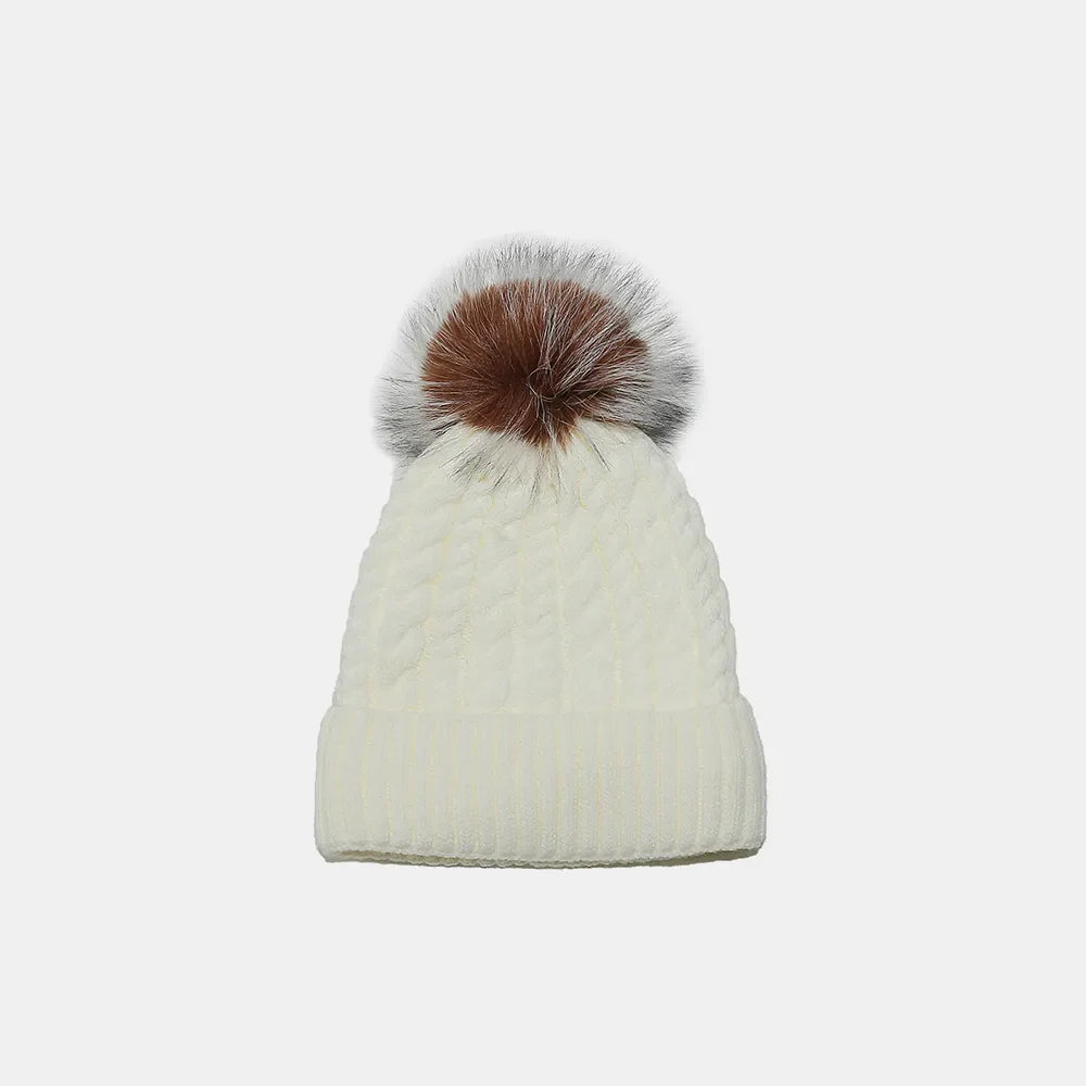 Ivory cable knit beanie with a multi-color pompom.
