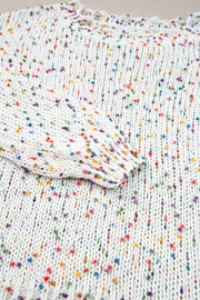 White confetti knit sweater with colorful flecks and distressed hem detail.