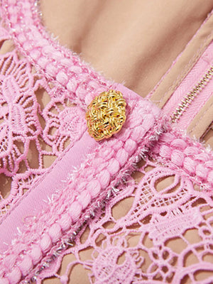 Pink lace midi dress with button detail and zipper closure.
