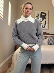 Black and white striped knit sweater with a contrast white collar and cuffs.