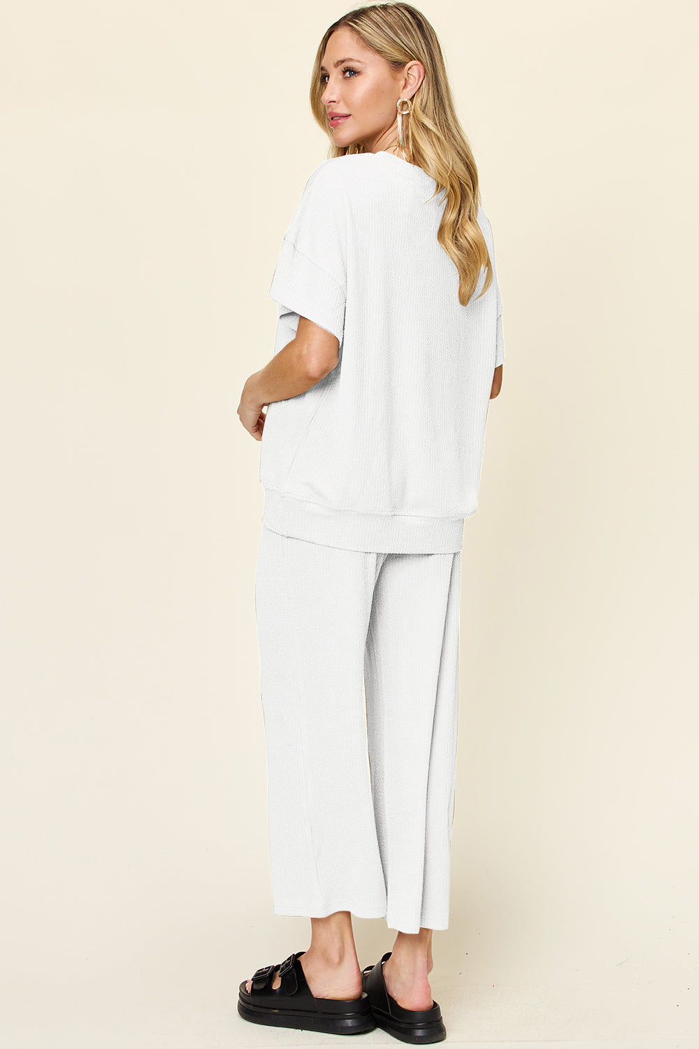 White waffle knit lounge set with short sleeve top and wide leg pants.