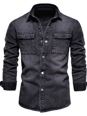 Faded denim utility shirt jacket in dark with buttoned chest pockets and cuffs.