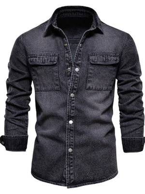 Faded denim utility shirt jacket in dark with buttoned chest pockets and cuffs.