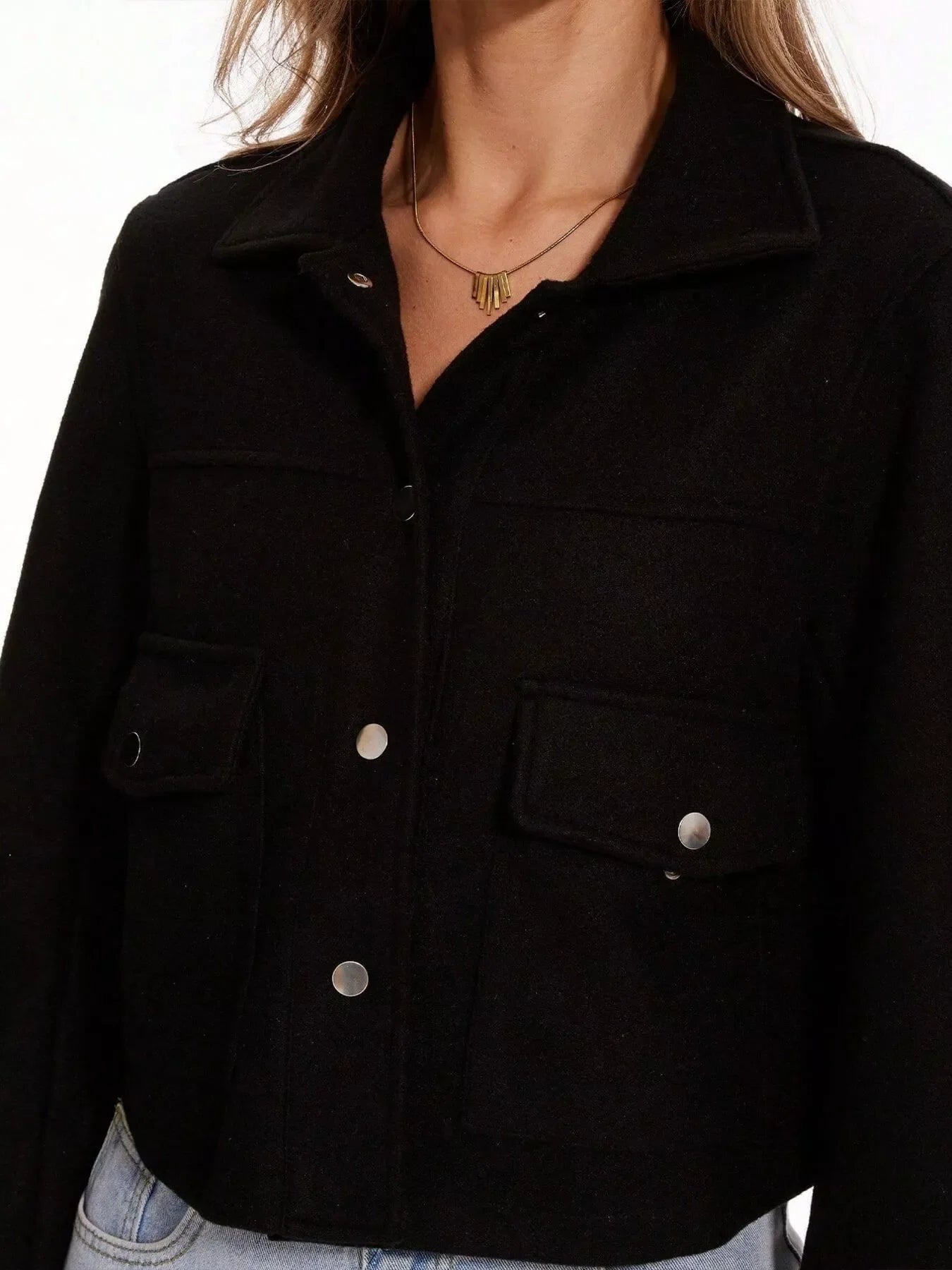Black trucker jacket with snap buttons and chest pockets.