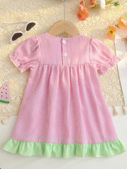 Baby dress in blush pink seersucker with white stripes, ruffled sleeves, and green hem.