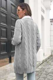 Longline cable knit cardigan in light gray acrylic with ribbed trim and crew neck.