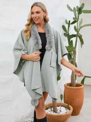 Gray faux fur collar wrap poncho with pom-pom detail and pocket.