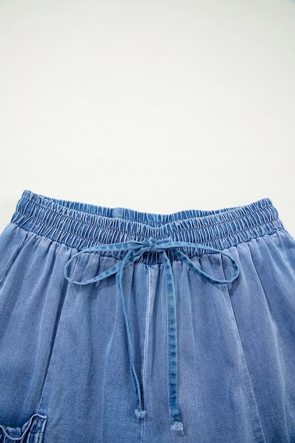 Relaxed denim maternity jeans with elastic drawstring waist and tie detail.