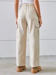Tan denim cargo pants with wide legs and buttoned flap pockets.
