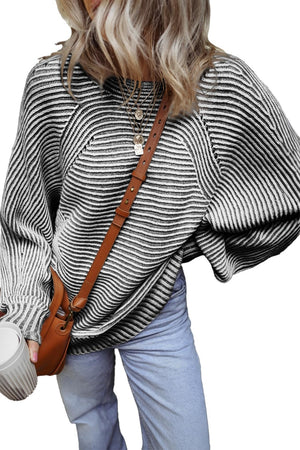 Textured stripe batwing knit sweater in black and white with a relaxed fit.