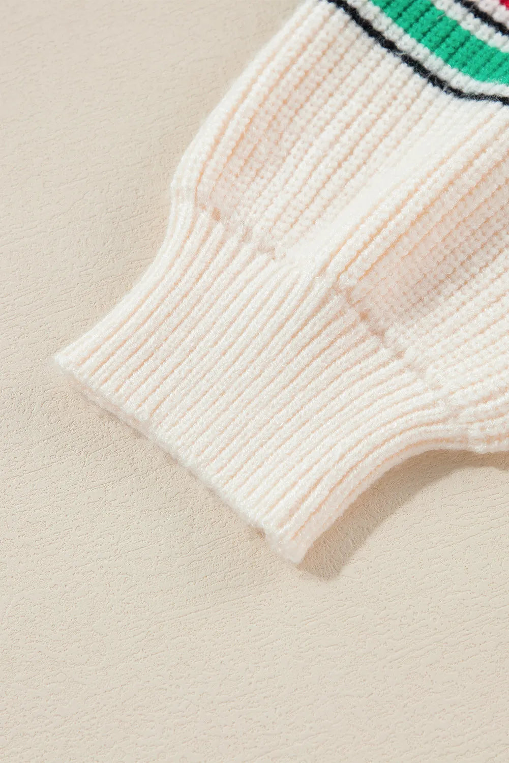 Ivory knit sweater sleeve detail with ribbed cuff and colorful stripe accent.