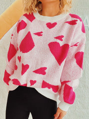Heart motif knit sweater in hot pink and white acrylic with crew neck.