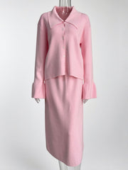 Pink ribbed knit cardigan with button-down front and flared cuffs, paired with a matching midi skirt.