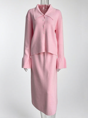 Pink ribbed knit cardigan with button-down front and flared cuffs, paired with a matching midi skirt.